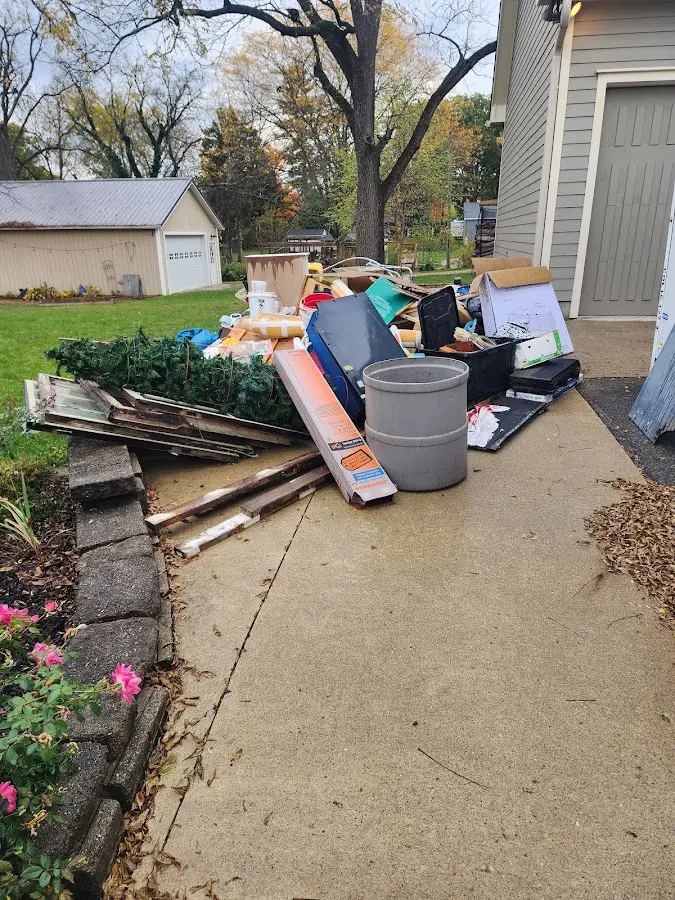 Dumpster being loaded with debris for Estate Cleanout Dumpster Rental in Navasota